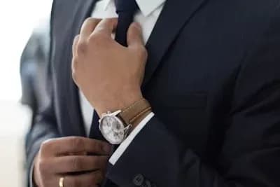 Man adjusting tie